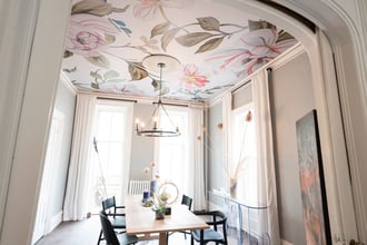 Clearly, it's time to rethink the ceiling and look to it as a sweet spot to make a major impact in a room. Here, our Camellias mural in Soft Light shines in the dining room imagined by Ana Claudia Interior Design.