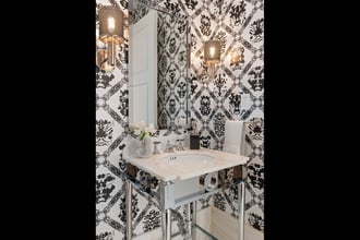 Designed by MHM Interiors, this Four Seasons NY powder room is big on personality thanks to our Andy Warhol Rorschach wallpaper. Photography by: Ryan Brown