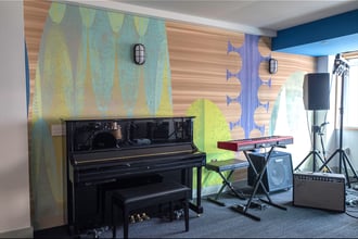 Designed by Rex Ray, Padauk is a mod mural that takes spaces—like this rehearsal studio—to the next level artistically. Padauk is scaled and cropped based on the provided wall dimensions, and we use special techniques to ensure zero pixelation at any size. It’s available on a number of substrates to suit needs; in this case we printed the design on acoustically transparent fabric.