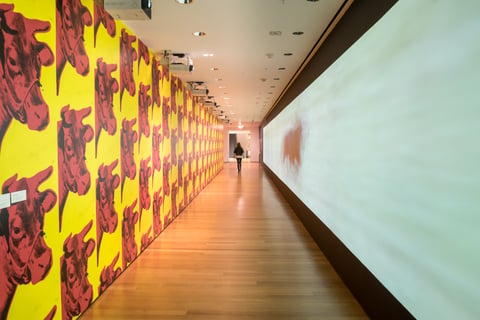 Sturtevant's version of Warhol's Cow wallpaper lines a long hallway that also features one of her less derivative works.