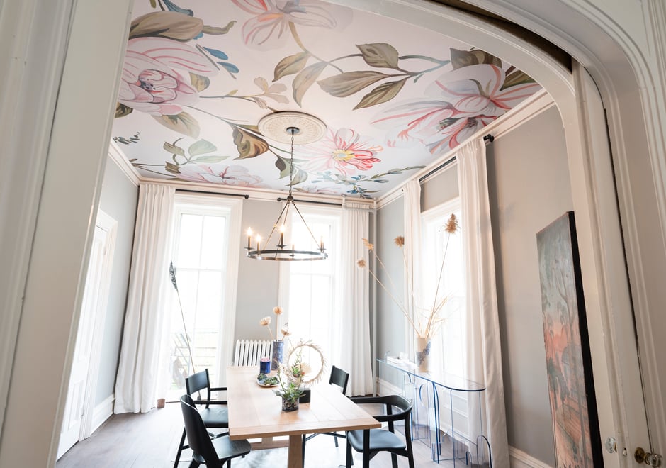 Clearly, it's time to rethink the ceiling and look to it as a sweet spot to make a major impact in a room. Here, our Camellias mural in Soft Light shines in the dining room imagined by Ana Claudia Interior Design.