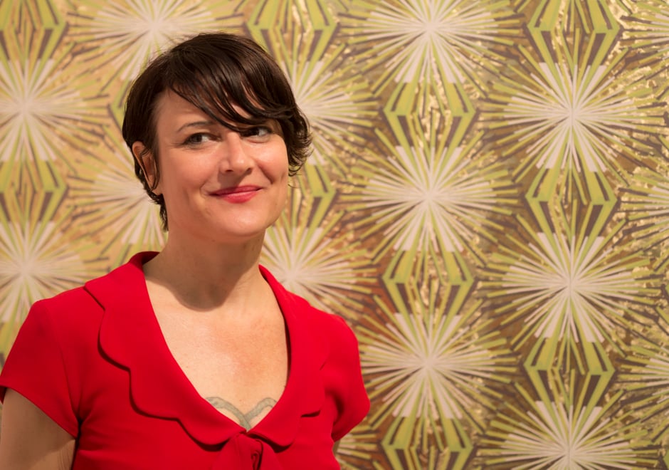 Designer and legend Jane Blevin in front of her Meteor Flower wallpaper at ICFF 2013