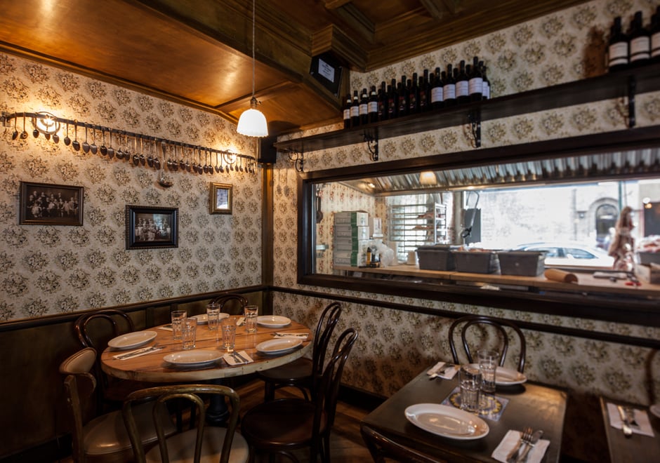 The custom floral wallpaper in the dining room