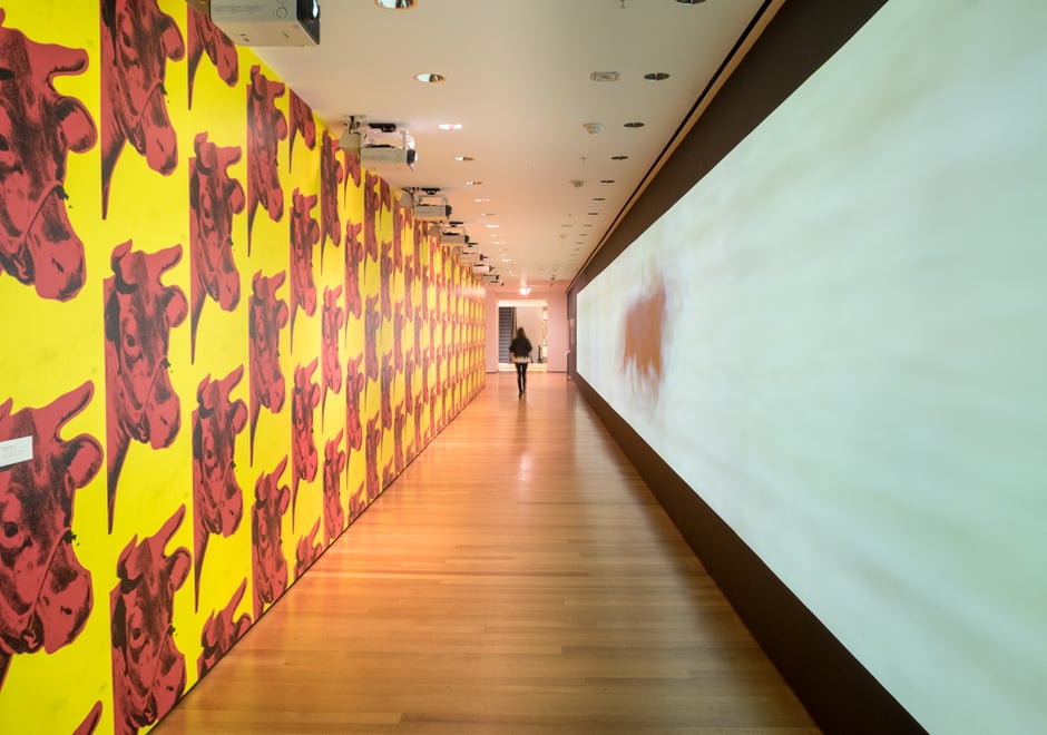 Sturtevant's version of Warhol's Cow wallpaper lines a long hallway that also features one of her less derivative works.