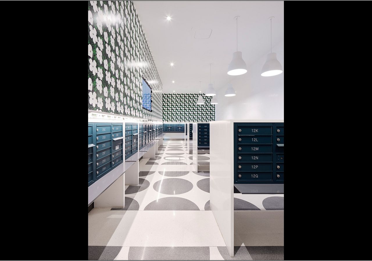 Designed by NYC based Bromley Caldari Architects, this letter-perfect mailroom is poppin' with our Warhol Small Flowers EZ Papes in Blanc. Photo cred: Van Sarki | @vansarki 