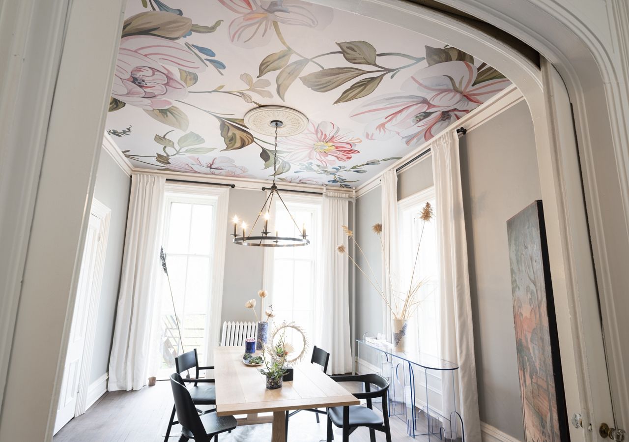 Clearly, it's time to rethink the ceiling and look to it as a sweet spot to make a major impact in a room. Here, our Camellias mural in Soft Light shines in the dining room imagined by Ana Claudia Interior Design.   